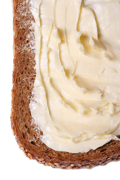 istock wholemeal bread with butter isolated on white 523391301