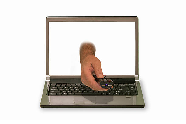 istock hand with remote control reaching out of laptop display 523392781