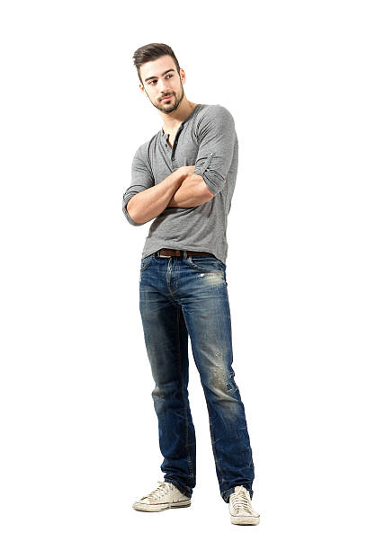 istock Young man in jeans looking away with crossed arms 523393921