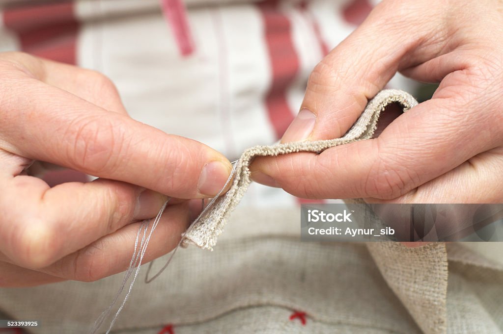 hand sewing with needle and thread Woman hands sewing with needle and thread Accessibility Stock Photo