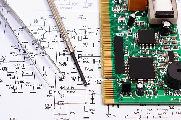 istock Printed circuit board and precision tools on diagram of electronics 523394240