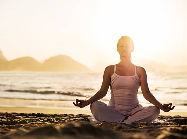 istock Yoga on the beach at sunset. 523395029