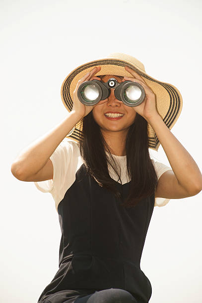 istock Pretty Asian young  woman seeking Binoculars . 523395048