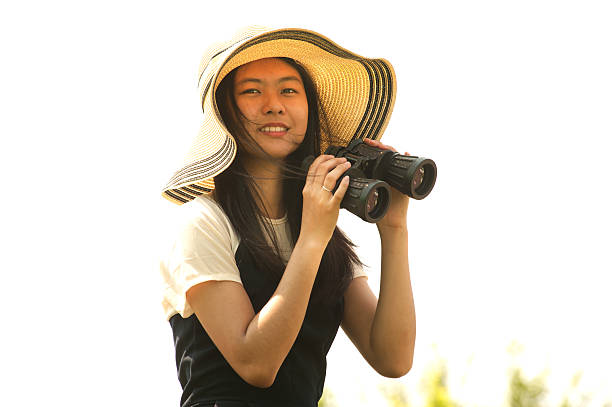 istock Pretty Asian young  woman seeking Binoculars . 523395142
