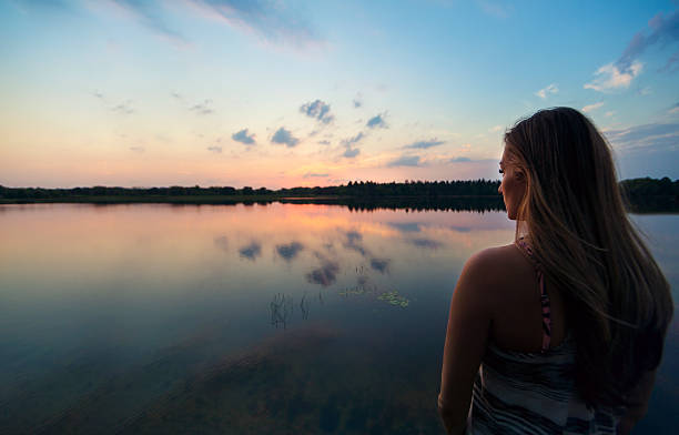 istock Woman enjoying the great outdoors watching a beautiful sunset 523396146