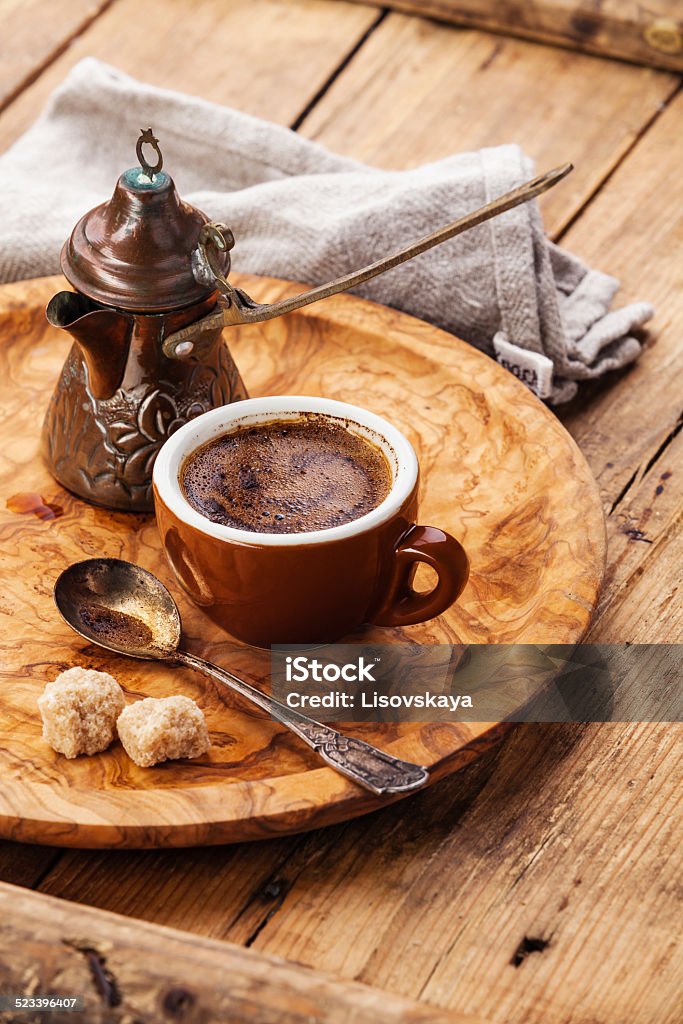 Cup of coffee and Cezve Cup of black coffee and Turkish Cezve on wooden background Backgrounds Stock Photo