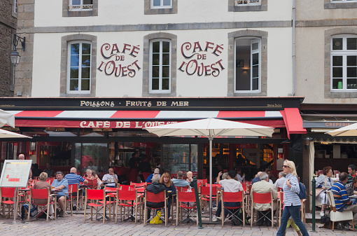 Saint-Malo, France - July 6, 2011: Cafe de l'Ouest in Saint-Malo, France. The cafe is located on the Place Chateaubriand and famous for their seafood. Saint-Malo is the main tourist attraction of Brittany in France.