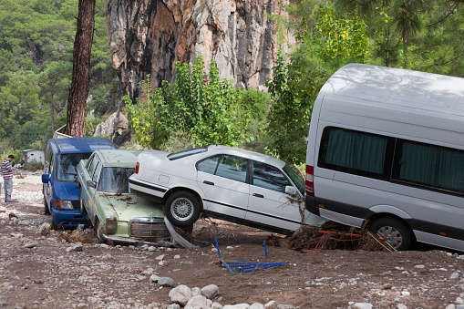 Olympos, Turkey - October 14, 2009: Wedged cars on dirt road after flood disaster in Olympos, Turkey. The floods destroyed many houses and swept away about 50 vehicles from the road into the sea. Olympos is a famous holiday spot in Antalyas Kumluca district.