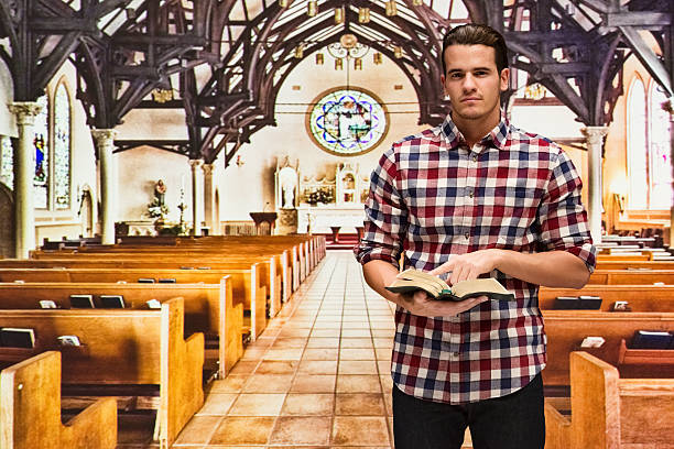 istock Man holding bible in church 523397044