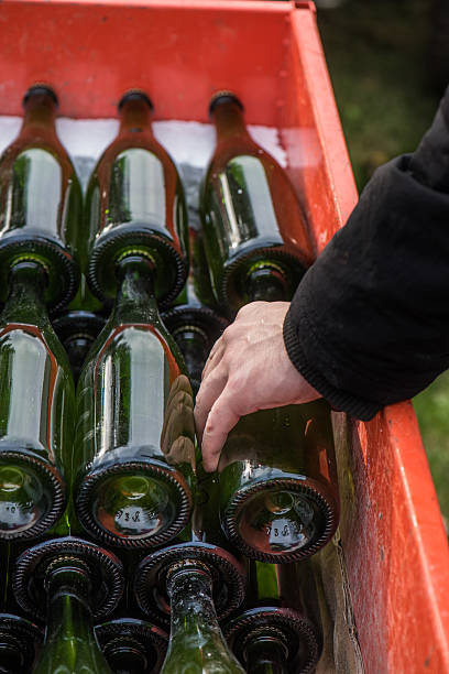 istock Hand placing champagne bottle to a box 523397609