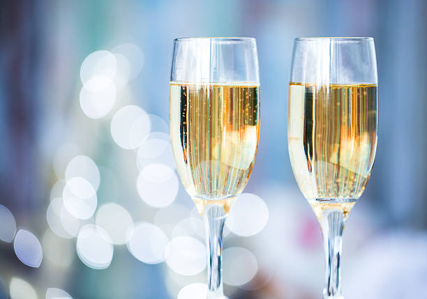 Two champagne glass on christmas bokeh background stock photo