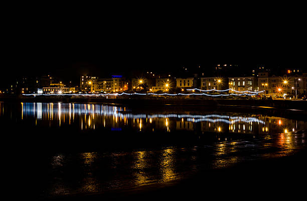 istock weston super mare at night with light reflection in water 523398261