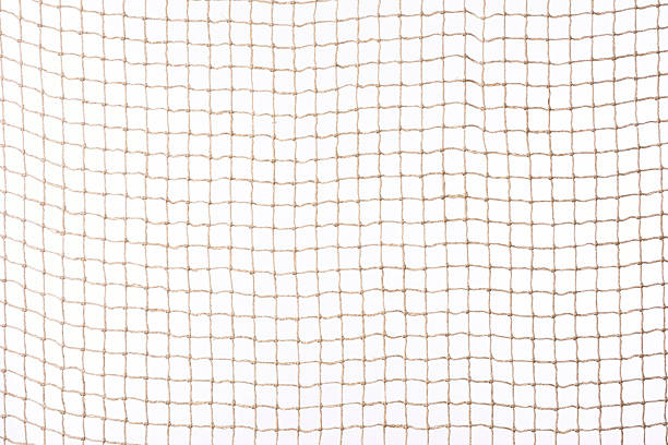 Isolated shot of beige netting against white background Beige netting isolated on white background. commercial fishing net photos stock pictures, royalty-free photos & images