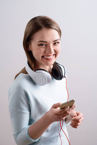 istock Delighted girl using smart phone 523401616