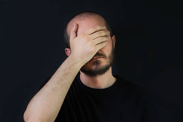istock Man on black background, face palm gesture 523401782