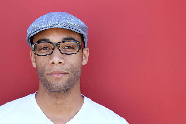 istock man in plain clothes wearing hat and glasses 523402454