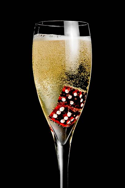 istock champagne flute with golden bubbles and red dice 523402928