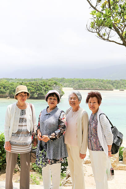 istock Elderly woman standing on the beach 523403538