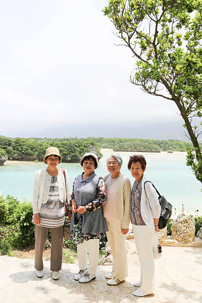 istock Elderly woman standing on the beach 523403642