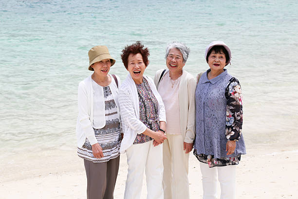 istock Elderly woman standing on the beach 523403748