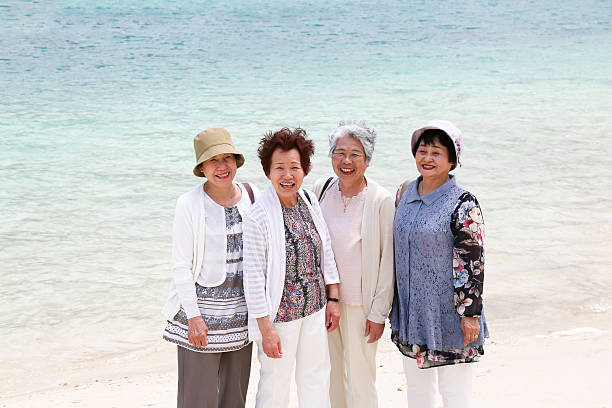 istock Elderly woman standing on the beach 523403798