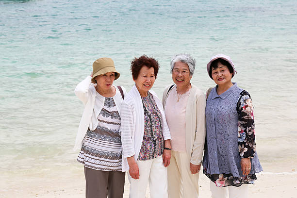 istock Elderly woman standing on the beach 523403822