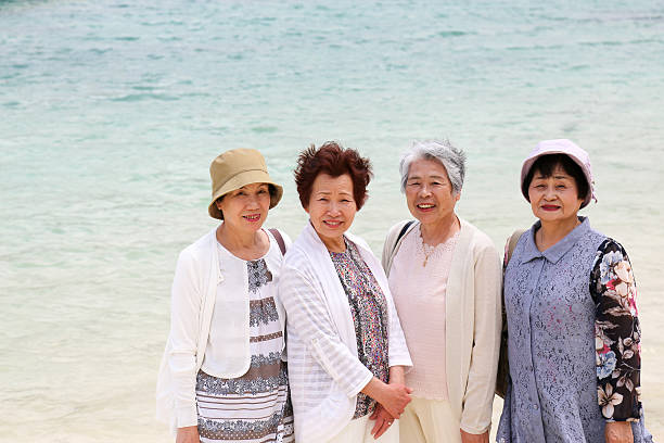 istock Elderly woman standing on the beach 523403854