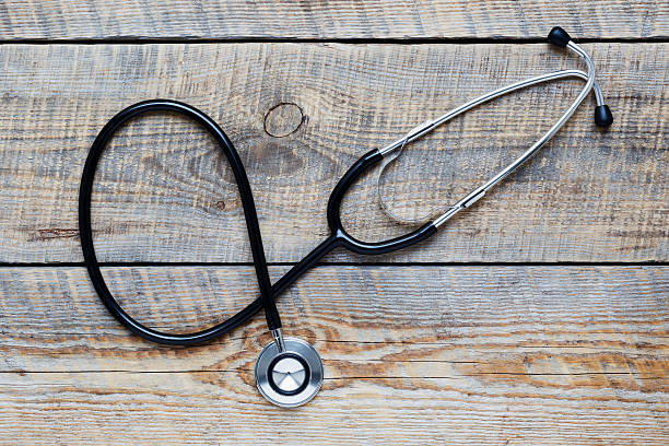 istock new stethoscope on wooden table isolated 523404058