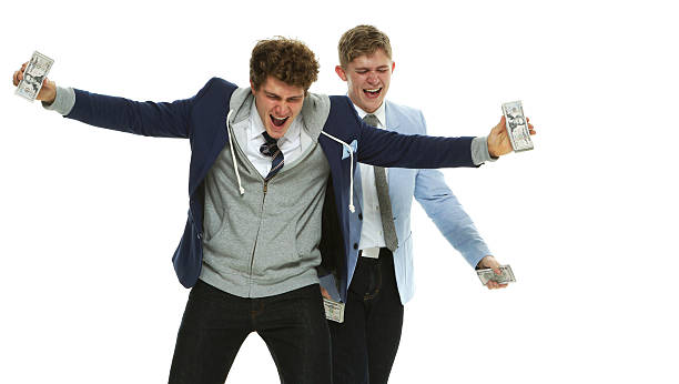 istock Brothers cheering with money 523404086