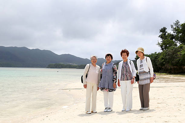 istock Elderly woman standing on the beach 523404180
