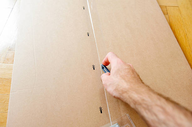 istock Man opening box with furniture 523407012