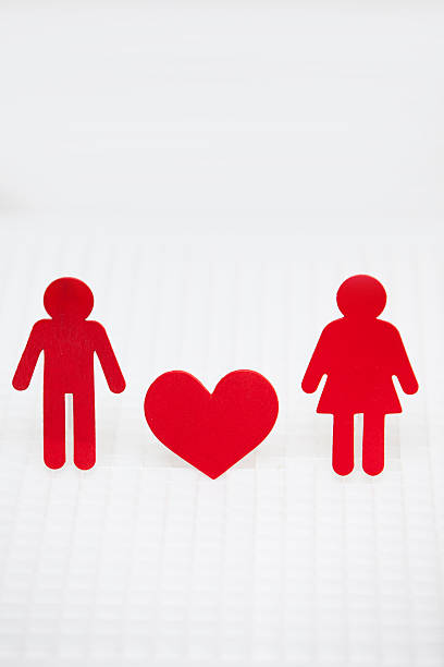 istock Man woman and heart figures on a white grid 523409989