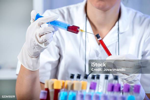 Scientist Working In Laboratory Stock Photo - Download Image Now - Blood Donation, Vial, Analyzing