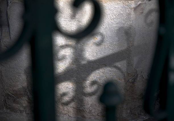istock shadow on stone wall of a church 523411233