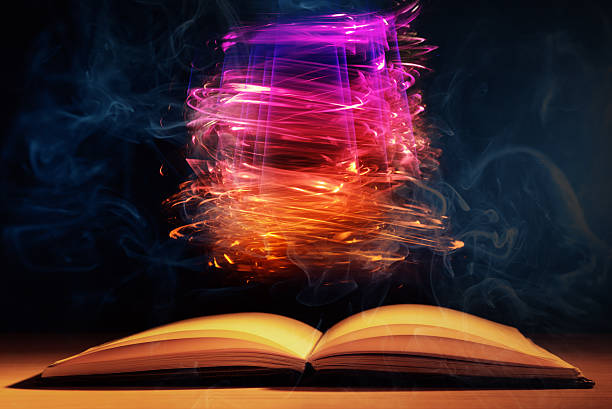 istock Open book against  defocused  lights abstract background 523427117