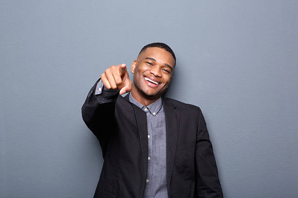 istock Young business man smiling and pointing finger 523427475