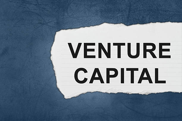 venture capital with white paper tears stock photo