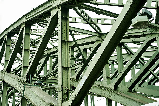 Part of green, old railroad construction with rivets. Lattice construction with rivets