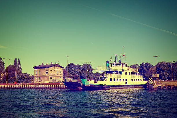 Car ferry boat is moored in port. Vintage toned photo.