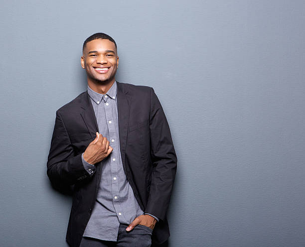 Fashionable african american man smiling Portrait of a fashionable african american man smiling on gray background business casual fashion stock pictures, royalty-free photos & images