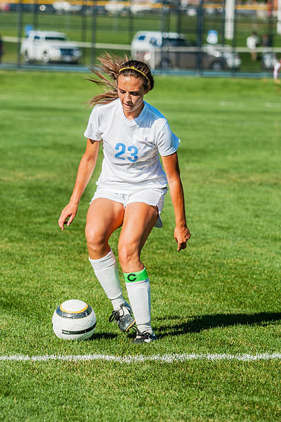 istock Attractive Soccer Girl in White Approaches for Soft Control Kick 523433715