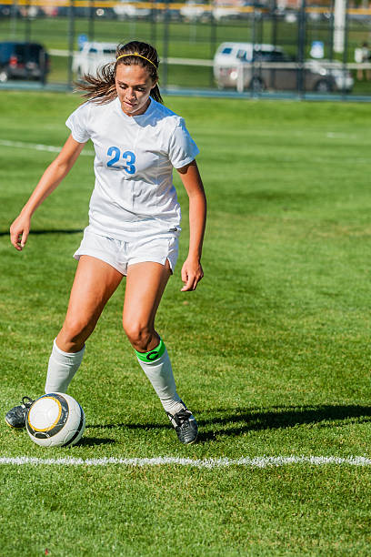 istock Attractive Female Soccer Player in White Executes Cutback Touch 523433717