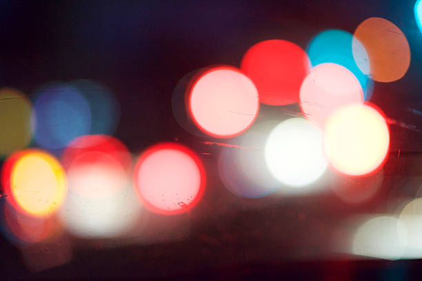 Blurred Car Lights Through a Windshield Blurred car head and tail lights seen through a windshield. police and firemen stock pictures, royalty-free photos & images
