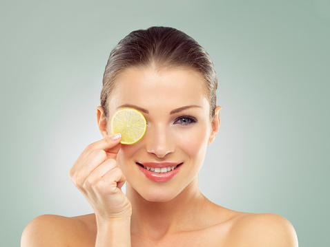 Studio portrait of a beautiful young woman posing with a slice of lemon in front of her eyehttp://azarubaika.com/iStockphoto/2014_05_09_Victoria_Beauty.jpg