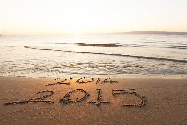 Happy New Year 2015 replace 2014 concept on the sea beach