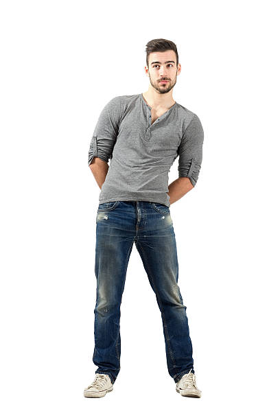 istock Confused young man with hand clasped on his back 523441961