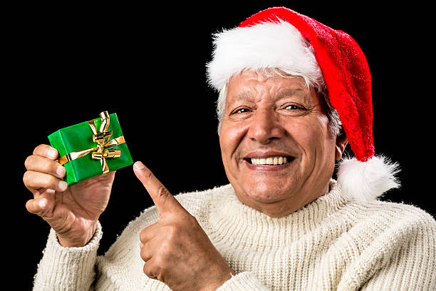 istock Cheerful Old Man Pointing At Green Wrapped Gift 523443357