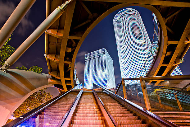 Azrieli centre in Tel Aviv Azrieli Center is a complex of skyscrapers in Tel Aviv. At the base of the center lies a large shopping mall. The center was originally designed by Israeli-American architect Eli Attia.The Azrieli Center is located on a 34,500 square meter site in Tel Aviv, Israel which was previously used as Tel Aviv's dumpster-truck parking garage. The Azrieli Center Circular Tower, is the tallest of the three towers, measuring 187 m (614 ft) in height. Construction of this tower began in 1996 and was completed in 1999. The tower has 49 floors, making it the tallest building in Tel Aviv and the second tallest in Israel tel aviv photos stock pictures, royalty-free photos & images