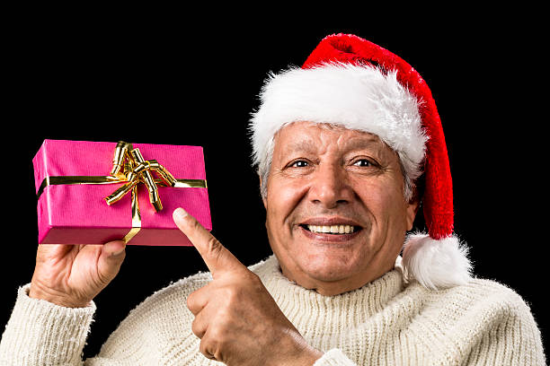 istock Joyous Old Man Pointing At Magenta Wrapped Gift 523445485