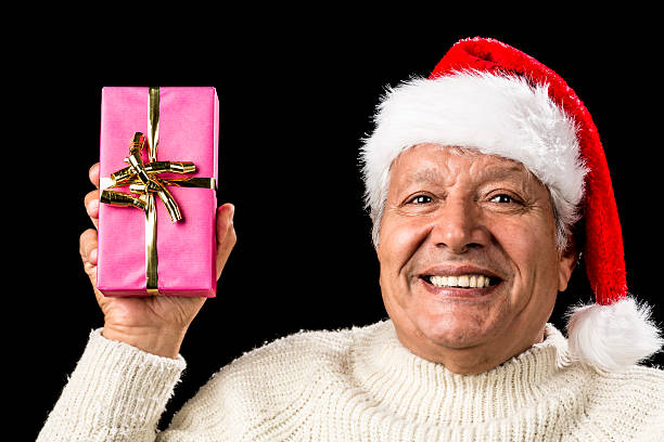 istock Merry Old Man Showcasing A Pink Wrapped Present 523445487
